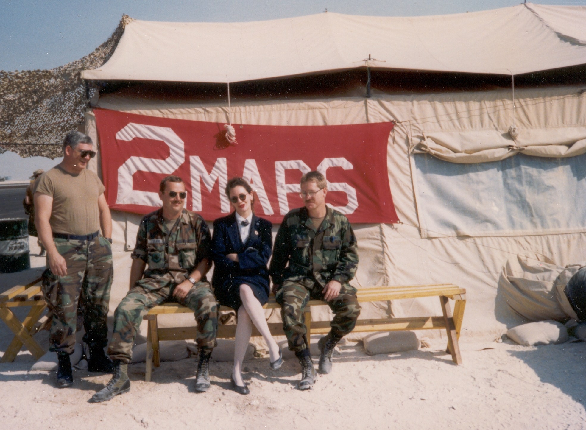 1990 Jane Andreassi poses for a photo with soldiers at a remote air base in Saudi Arabia.  Pan Am had just delivered a group of soldiars to Saudi Arabia as part of the build up for the first Gulf War and Jane had a few minutes on the ground before leaving to return to Europe.